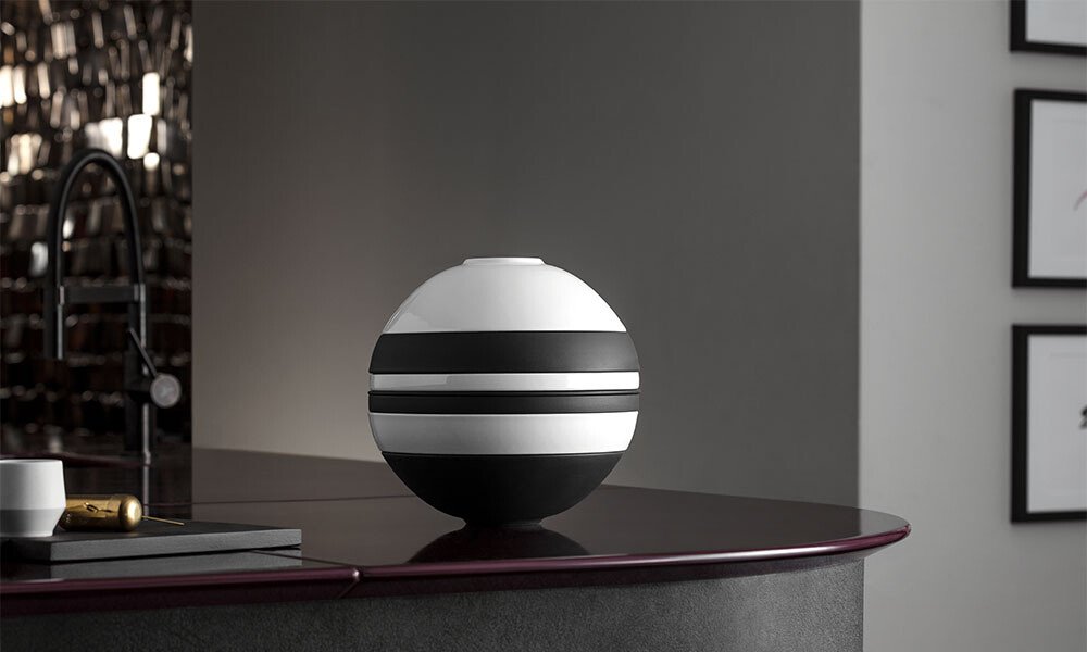 Geschirr-Set La Boule von Villeroy &amp; Boch auf dunkler, glänzender Theke in stilvoll modernem Innenraum.